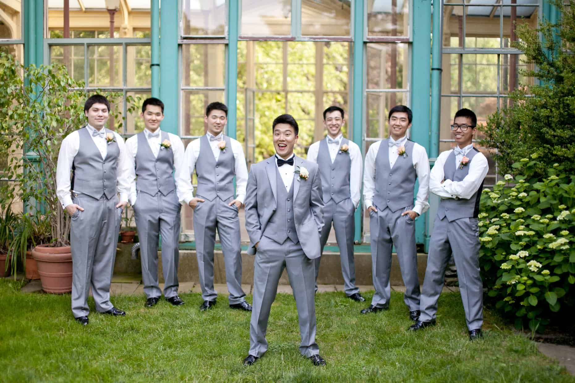 Groom with groomsman in front of the mansion at Rockwood Carriage House