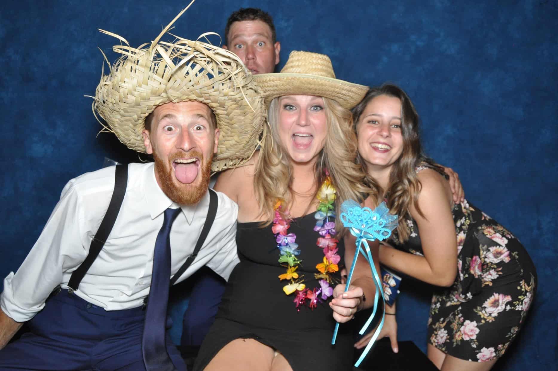photo booth picture with straw hats and wand prop