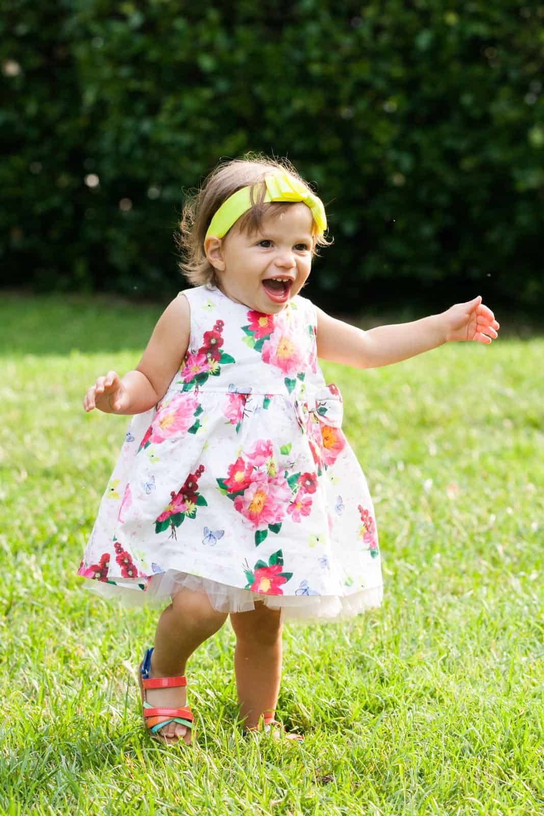 young girl in flower dress and yellow headband