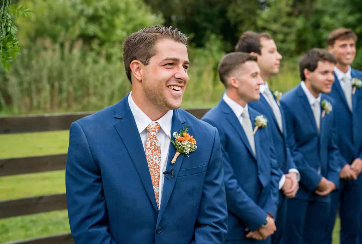 groom reacts to bride walking down the aisle
